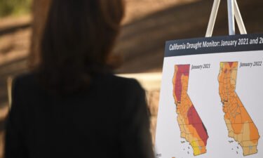 Vice President Kamala Harris reads a briefing poster about drought conditions at the US Forest Service Del Rosa fire station in San Bernardino