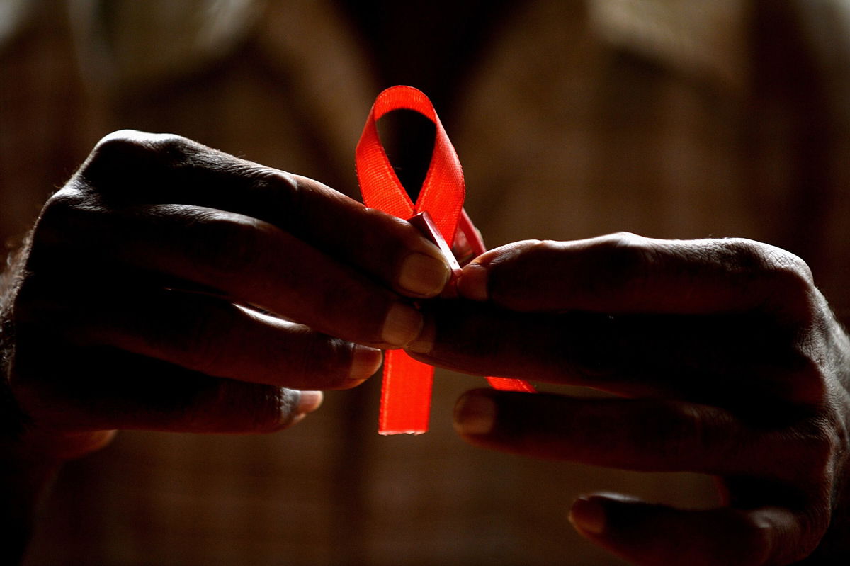 <i>MANJUNATH KIRAN/AFP/Getty Images</i><br/>An HIV-positive person from the Support and Care Centre of the Sumanahalli Society prepares 'red ribbons' on the eve of World Aids Day in Bangalore.