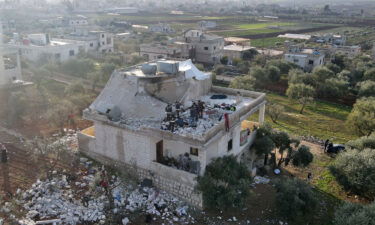Syrians gather at the scene of a raid by US special operations on February 3