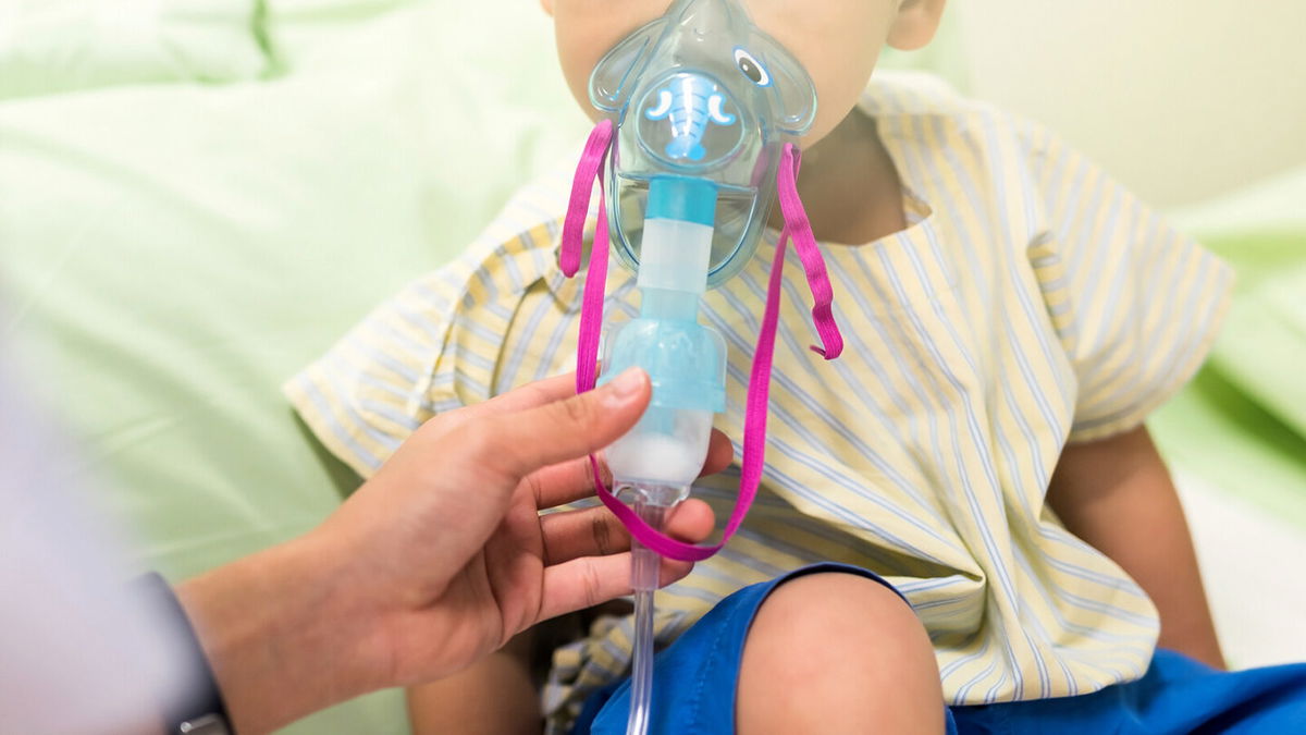 <i>Shutterstock</i><br/>A 3-year-old patient in the hospital receives medication via an inhalation mask to treat Respiratory Syncytial Virus (RSV).