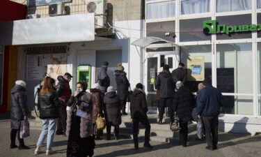 Residents wait outside the Ukrainian bank PrivatBank
