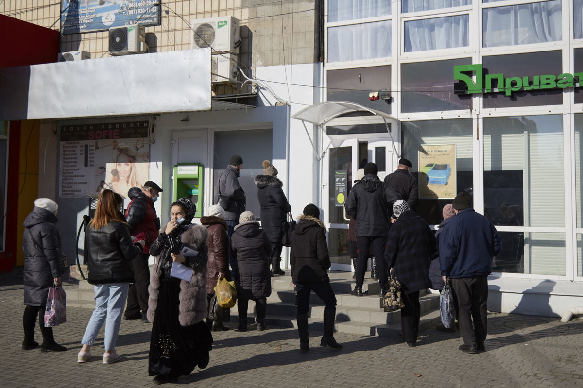 <i>Pierre Crom/Getty Images</i><br/>Residents wait outside the Ukrainian bank PrivatBank