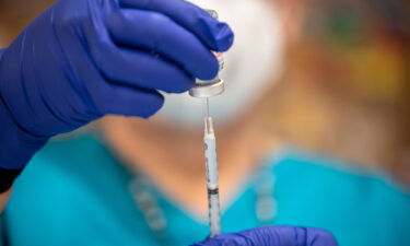 A nurse fills up a syringe with the Moderna Covid-19 vaccine at a vaccination site at a senior center on March 29