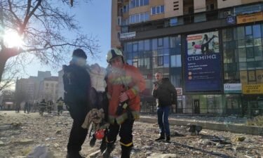 Residents being evacuated from damaged apartment building in Kyiv on February 26.