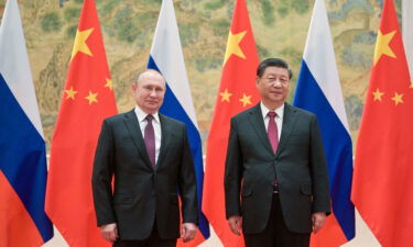 Putin and Xi pose during a meeting on Friday in Beijing.