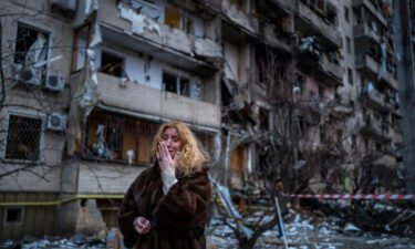 Natali Sevriukova reacts next to her house following a rocket attack on Kyiv on Friday