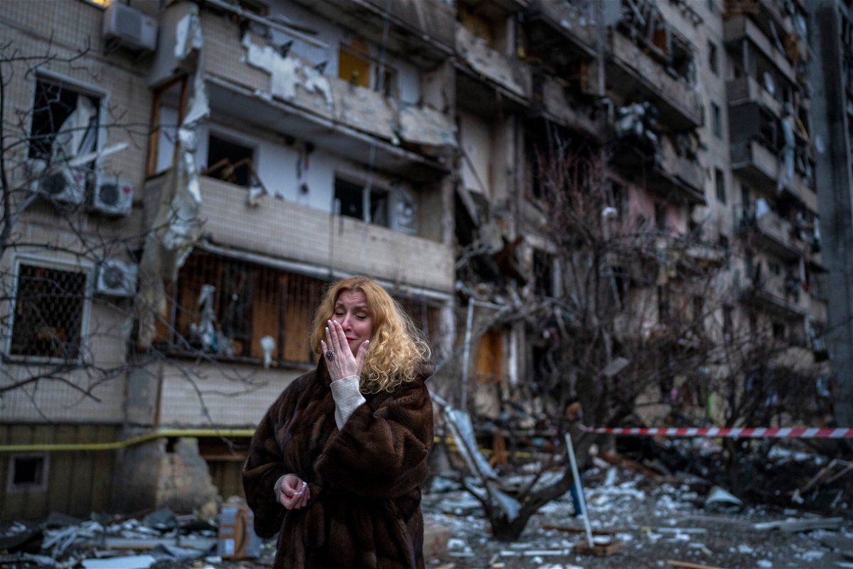 <i>Emilio Morenatti/AP</i><br/>Natali Sevriukova reacts next to her house following a rocket attack on Kyiv on Friday