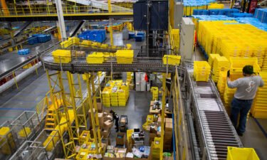 Bins move along a conveyor at an Amazon fulfillment center on Cyber Monday in Robbinsville