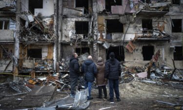 People look at damage following an attack on the city of Kyiv
