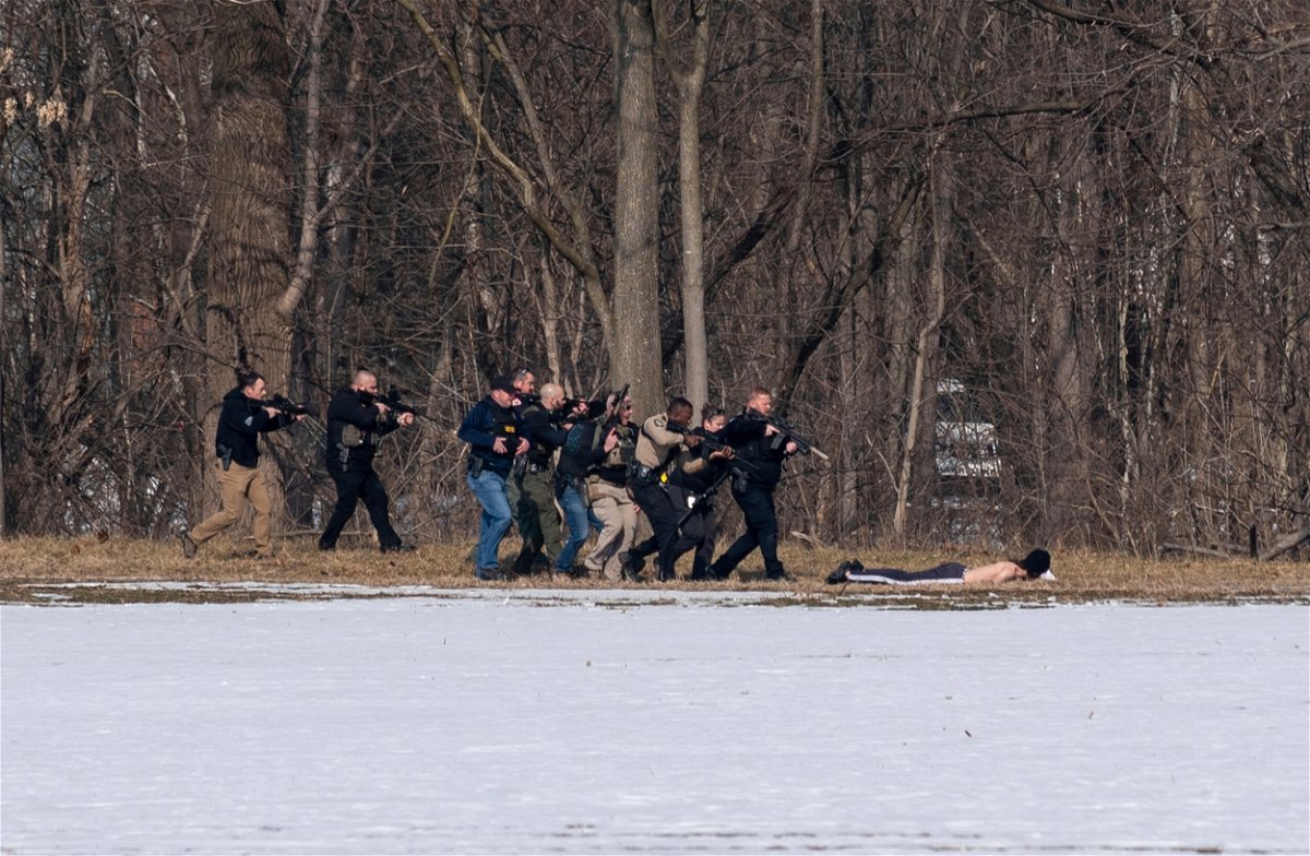 <i>Daniel Lin/Daily News-Record/AP</i><br/>Police approach a person of interest on the south bank of the North River in Bridgewater