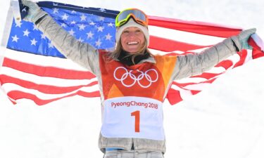 Jamie Anderson holds up a U.S. flag