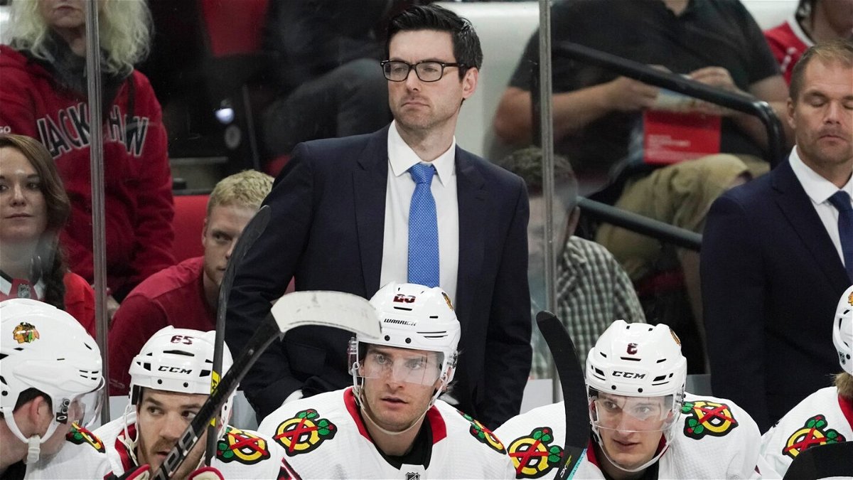 Jeremy Colliton looks on from behind the bench.