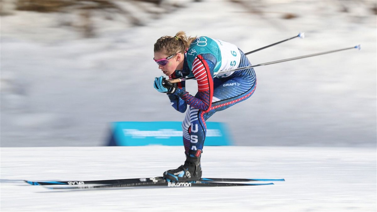 Jessie Diggins in a crouching position as she skis a race
