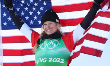 Lindsey Jacobellis holds up an American flag