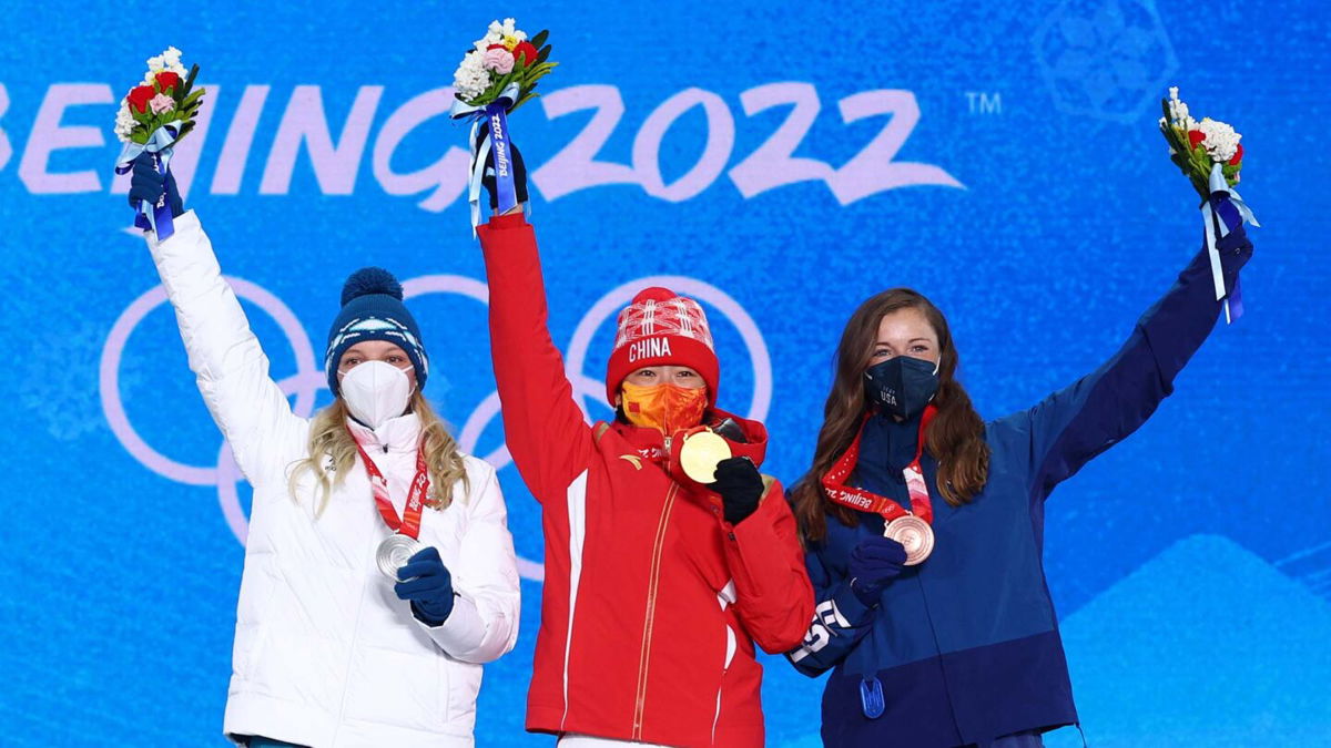 The three medalists pose for a photo