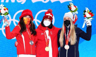 The three medalists show off their medals for a photo