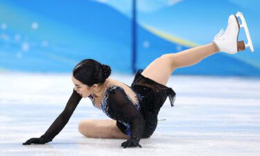 Karen Chen falls onto the ice