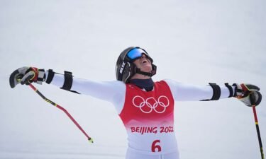 Sara Hector from Sweden celebrates at the finish after winning the women's giant slalom at the 2022 Winter Olympics.