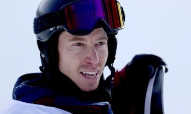 Shaun White stands with his snowboard