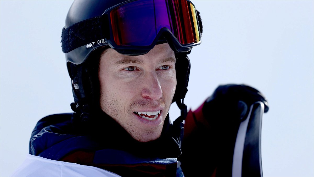 Shaun White stands with his snowboard