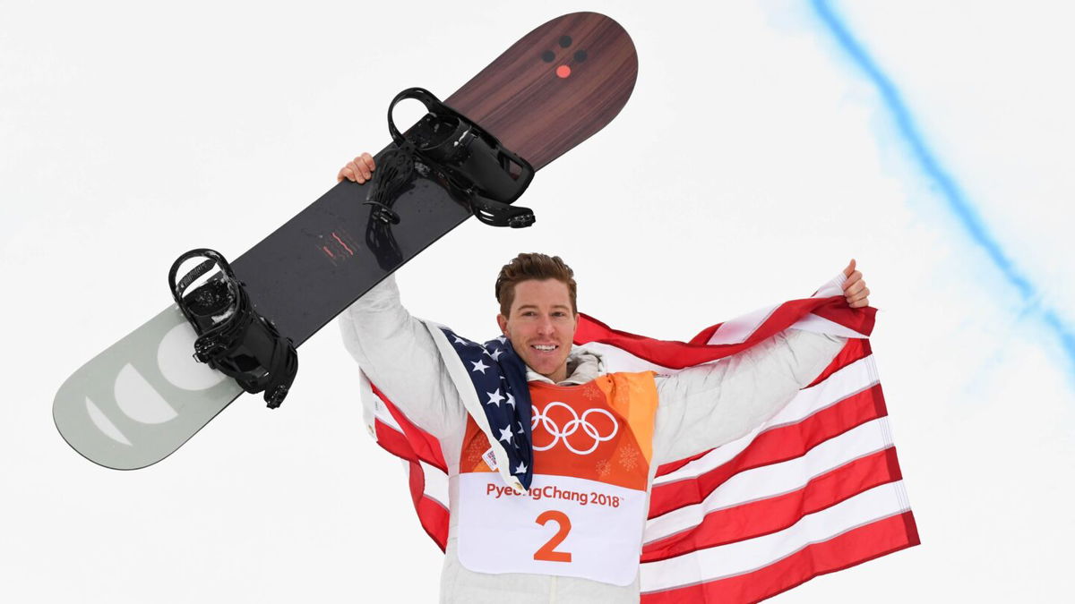 Shaun White holds his snowboard at the 2018 Winter Olympics