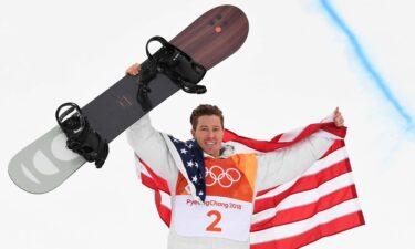 Shaun White holds his snowboard at the 2018 Winter Olympics