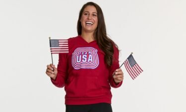 Emily Sweeney waves 2 U.S. flags