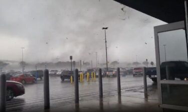 A tornado rips through a Walmart parking lot in Round Rock