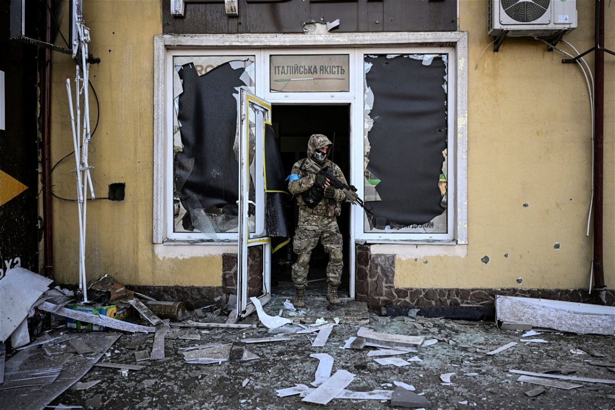 <i>Aris Messinis/AFP/Getty Images</i><br/>A Ukrainian serviceman exits a damaged building after shelling in Kyiv on March 12.