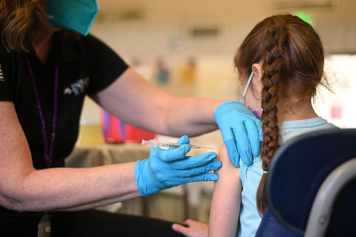 <i>Robyn Beck/AFP/Getty Images</i><br/>A nurse administers a pediatric dose of the Covid-19 vaccine to a girl in Los Angeles