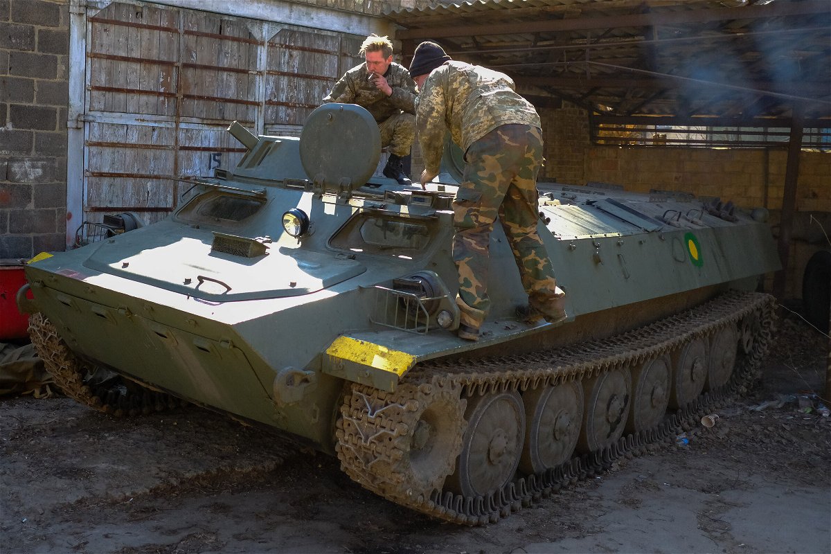 <i>Vasco Cotovio/CNN</i><br/>Soldiers from Ukraine's Territorial Defense Forces inspect a Russian armored personnel carrier they captured on the battlefield.
