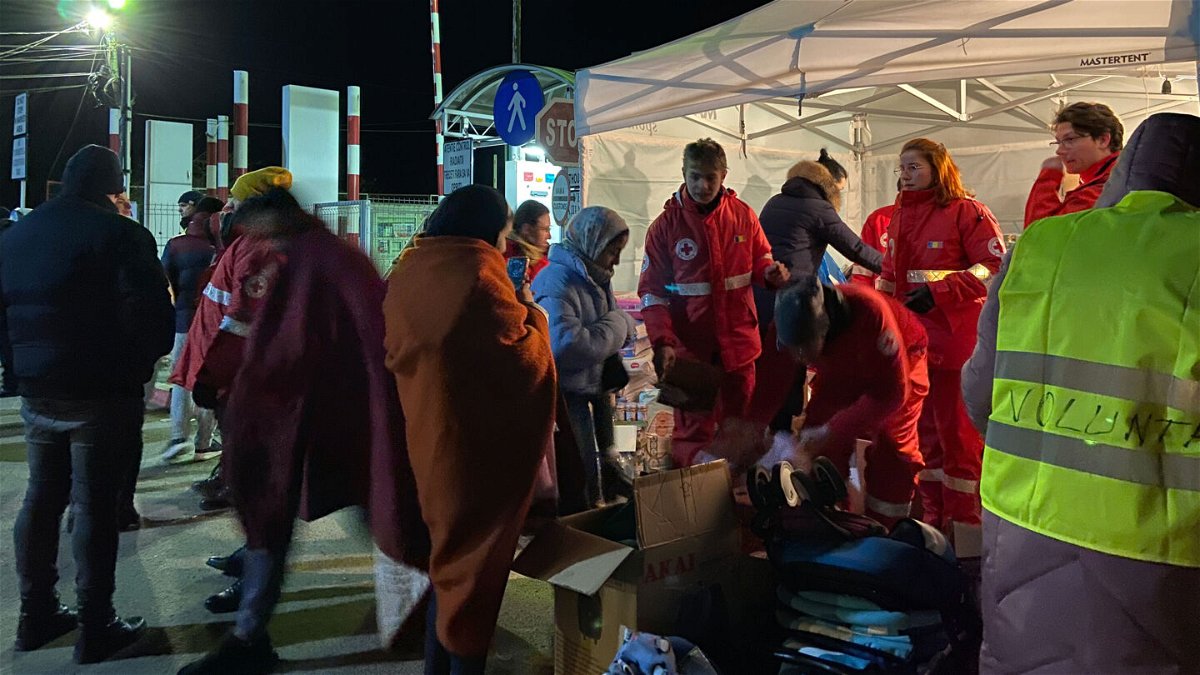 <i>Denise Hruby for CNN</i><br/>Romanian Red Cross workers hand out blankets to refugees from Ukraine who crossed the border at Sighetu Marmatiei
