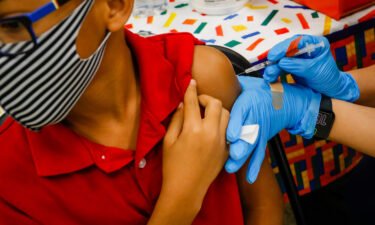 A child receives a dose of the Pfizer-BioNTech Covid-19 vaccine at an elementary school vaccination site for children in Miami on Monday