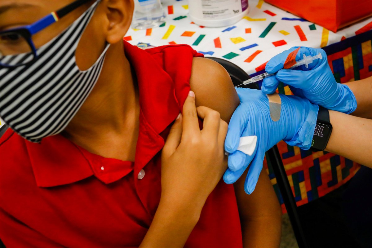 <i>Eva Marie Uzcategui/Bloomberg/Getty Images</i><br/>A child receives a dose of the Pfizer-BioNTech Covid-19 vaccine at an elementary school vaccination site for children in Miami on Monday