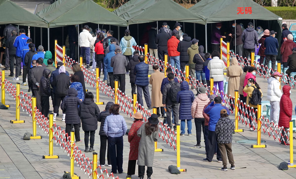 <i>Costfoto/Future Publishing /Getty Images</i><br/>People queue for Covid tests in Yantai