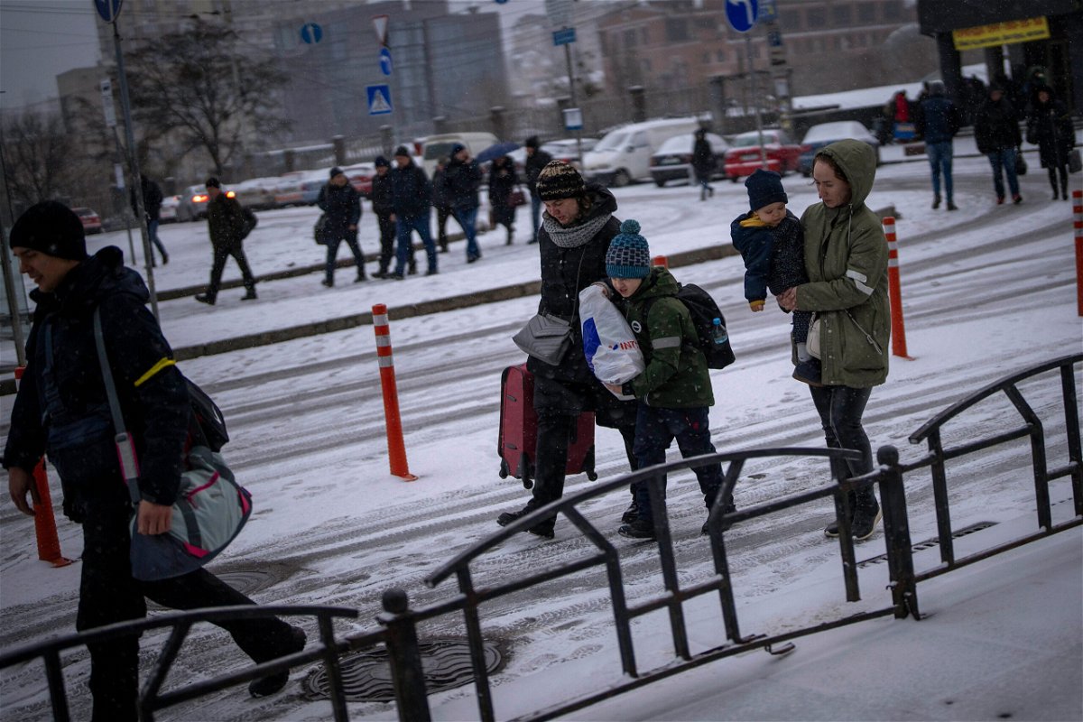 <i>Emilio Morenatti/AP</i><br/>People arrive at a train station as they try to leave Kyiv