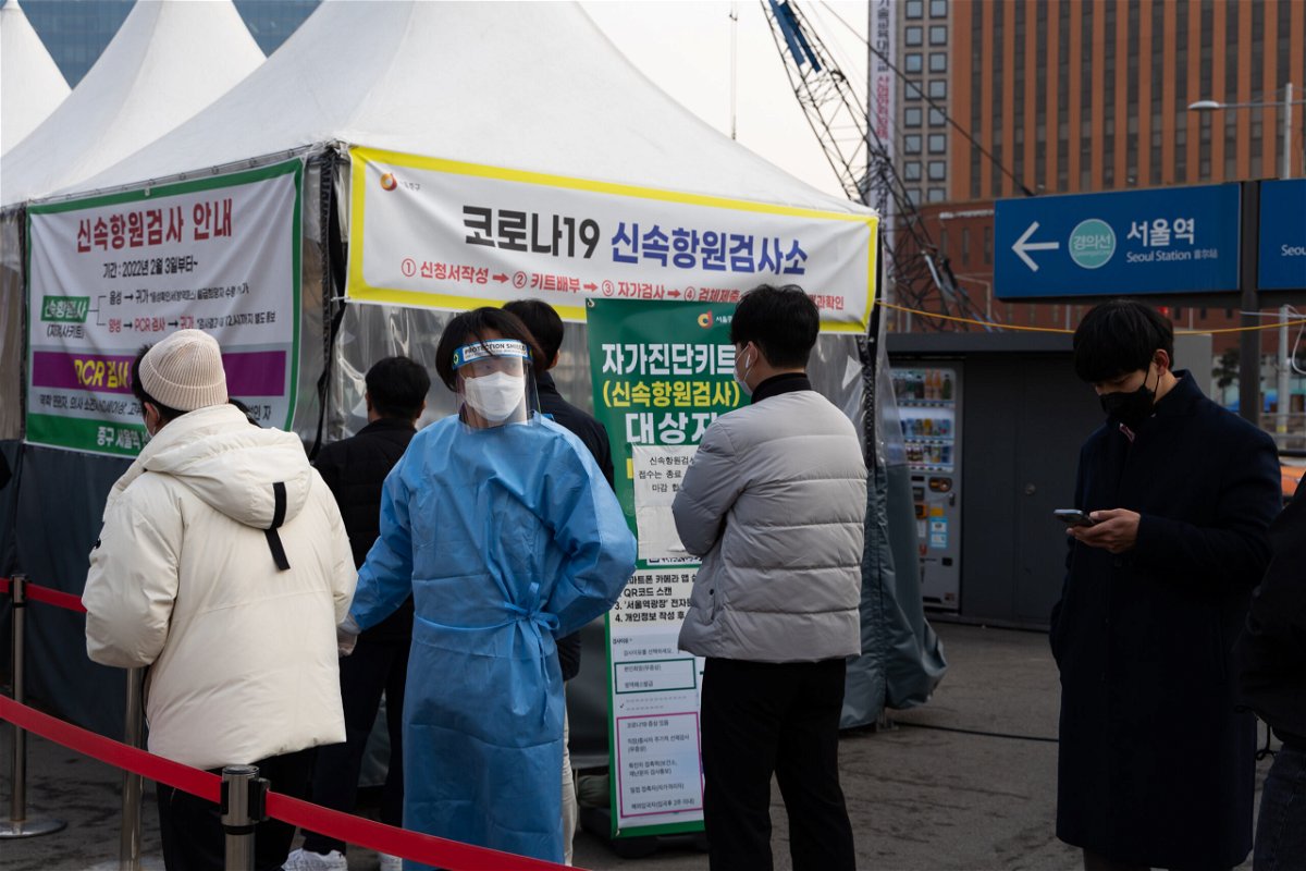 <i>SeongJoon Cho/Bloomberg/Getty Images</i><br/>Members of the public wait in line at a temporary Covid-19 testing station set up outside Seoul Station on March 4.