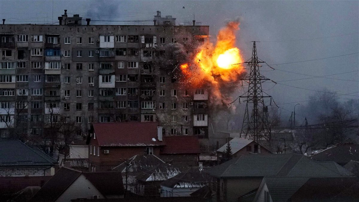 <i>Evgeniy Maloletka/AP</i><br/>An explosion is seen in an apartment building after Russian's army tank fires in Mariupol