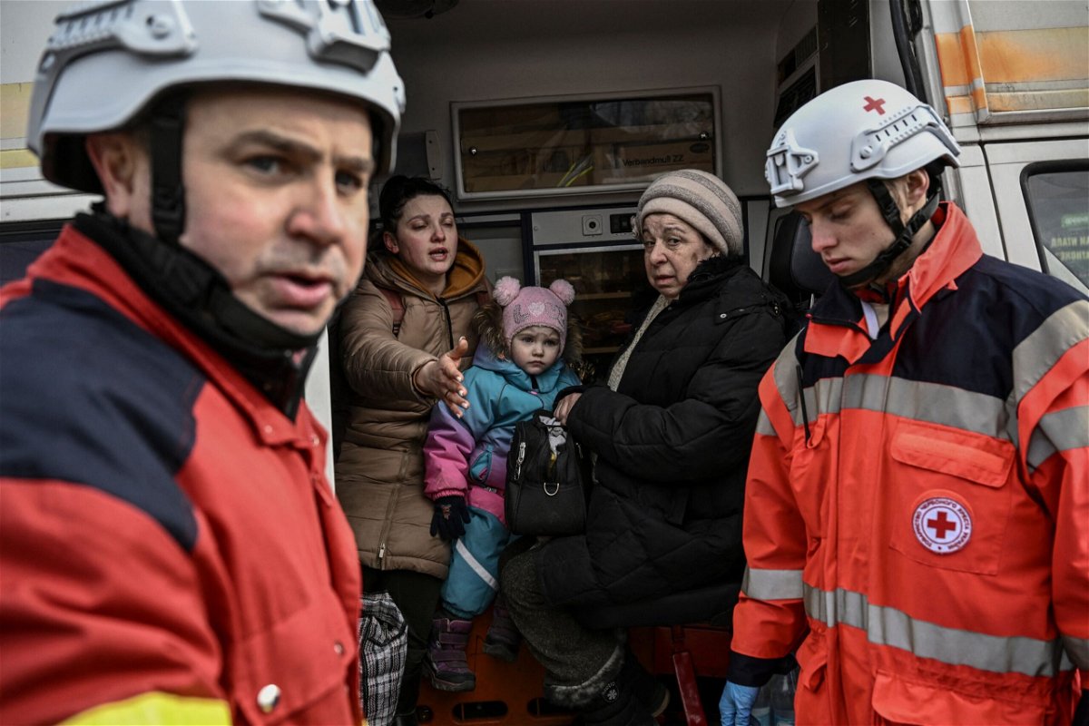 <i>Aris Messinis/AFP/Getty Images</i><br/>Members of the Red Cross help people who flee the city of Irpin