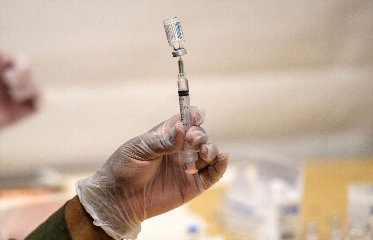 <i>Angela Weiss/AFP/Getty Images</i><br/>A healthcare worker prepares a syringe with a vial of the J&J/Janssen Covid-19 vaccine at a temporary vaccination site at Grand Central Terminal train station on May 12