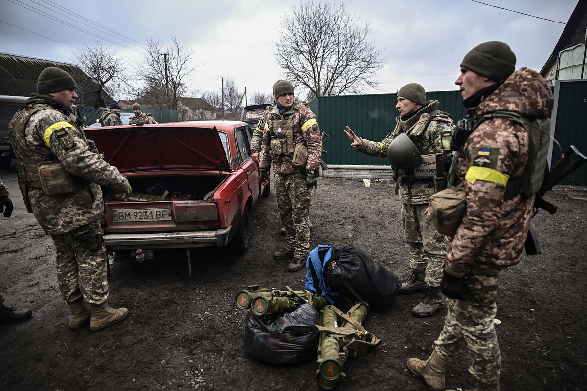 <i>Aris Messinis/AFP/Getty Images</i><br/>Ukrainian soldiers unload weapons from the trunk of an old car northeast of Kyiv