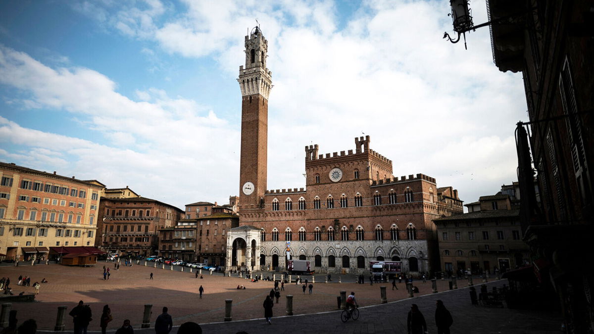 <i>MARCO BERTORELLO/AFP/AFP via Getty Images</i><br/>People walk in Piazza del Campo on March 4