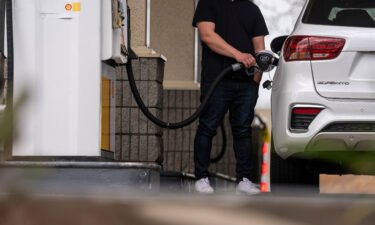 A driver holds a fuel nozzle at a Shell gas station in Hercules
