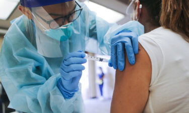 A nurse administers a flu vaccination shot in Lakewood