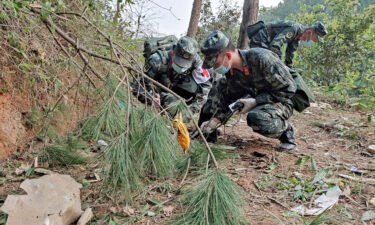 Paramilitary police officers search the site of the China Eastern Airlines plane crash in China's Guangxi province on March 22.