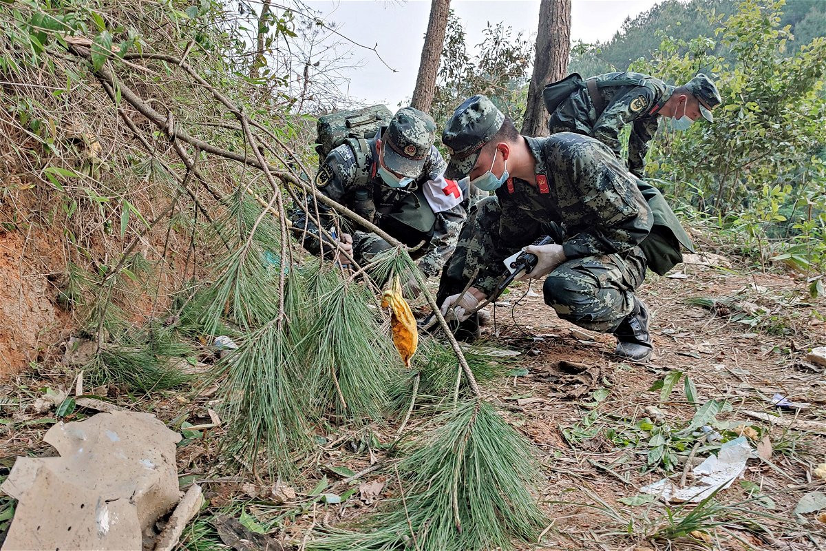 <i>CNS/AFP/Getty Images</i><br/>Paramilitary police officers search the site of the China Eastern Airlines plane crash in China's Guangxi province on March 22.