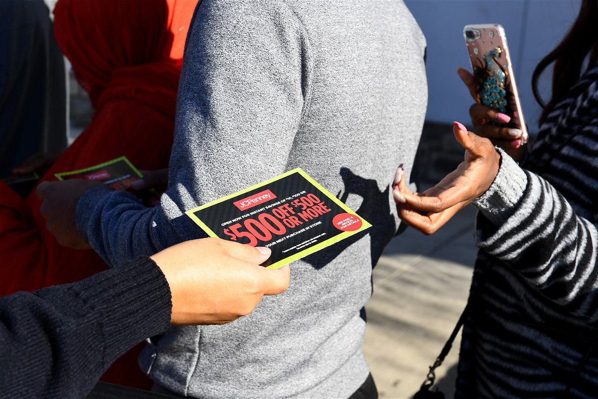 <i>Katherine Frey/The Washington Post/Getty Images</i><br/>J.C. Penney employees hand out coupons to those waiting to get into the store on Thanksgiving Day November 23
