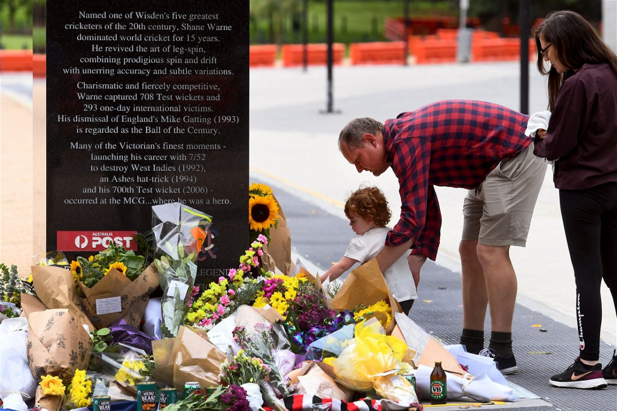 <i>William West/AFP/Getty Images</i><br/>Flowers are placed at the base of a statue dedicated to Warne at the MCG.