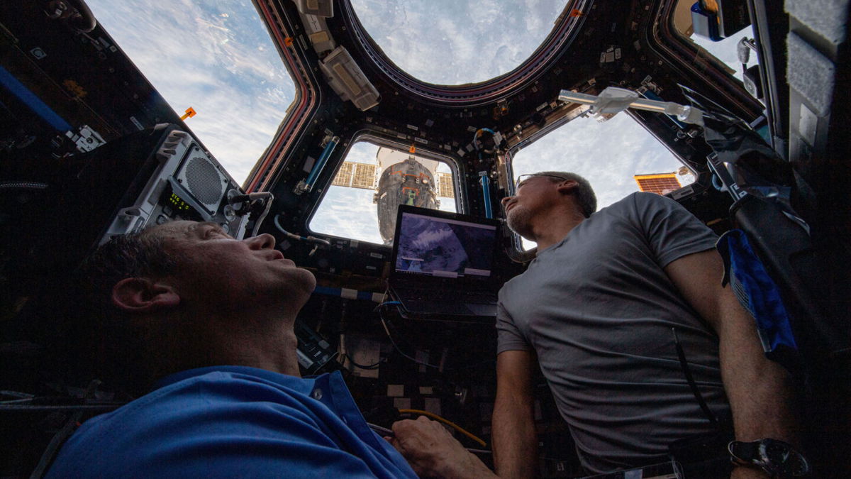 <i>NASA</i><br/>NASA engineers Thomas Marshburn (L) and Mark Vande Hei peer at the Earth from inside the International Space Station on February 4.