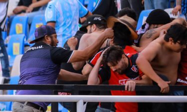 Fans clash in the stands during the match between Querétaro and Atlas.